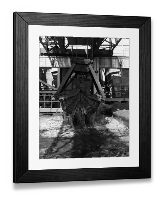 Framed Print : The grab crane, rises out of the ash settling tank, drawing off the ash at the Aberthaw A Framed Print : The grab crane, rises out of the ash settling tank, drawing off the ash at the Aberthaw A