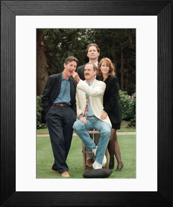 Framed Print : Jamie Lee Curtis, John Cleese (centre in the white jacket and jeans)