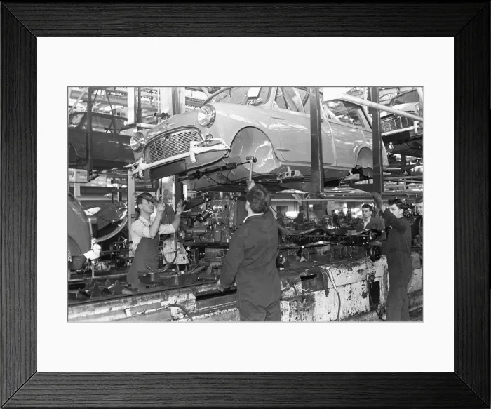 Framed Print : The front axel and engine seen here being mounted on to a Austin Mini on the production Framed Print : The front axel and engine seen here being mounted on to a Austin Mini on the production