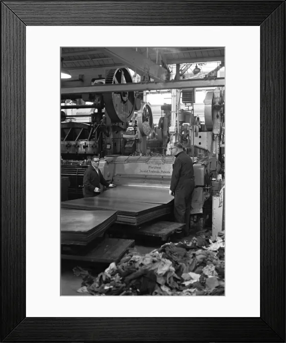 Framed Print : Metal sheets are fed into the body panel press at the The Austin Mini production line Framed Print : Metal sheets are fed into the body panel press at the The Austin Mini production line