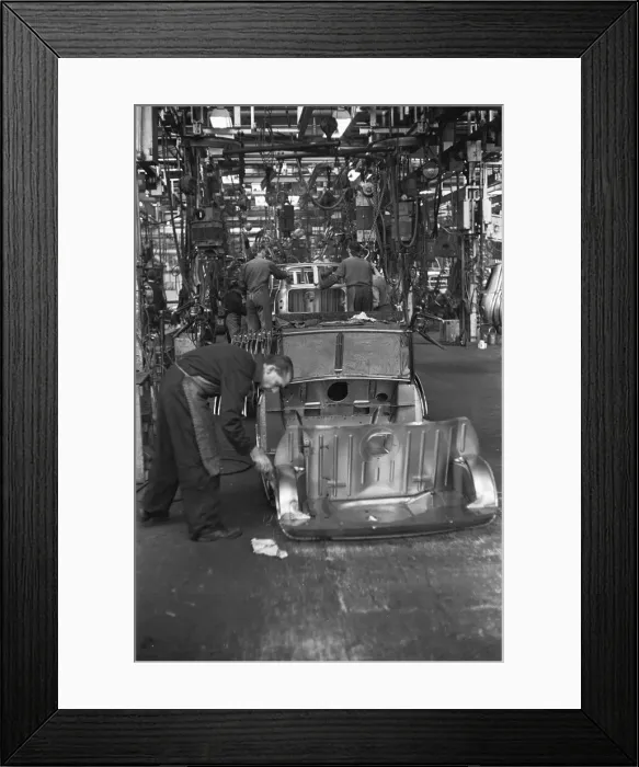 Framed Print : Austin Mini body panels are assembled prior to welding and being placed on the production Framed Print : Austin Mini body panels are assembled prior to welding and being placed on the production