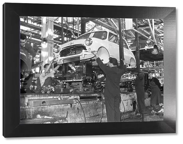 The engine is fitted to a Austin Mini on the production line, Longbridge. 10th March 1963