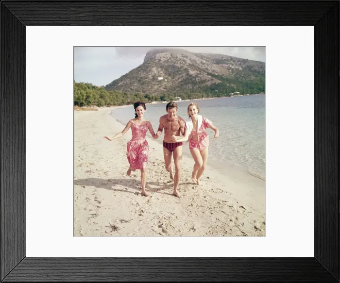 Framed Print : Group of friends enjoying themselves during a day out at the seaside in Greece