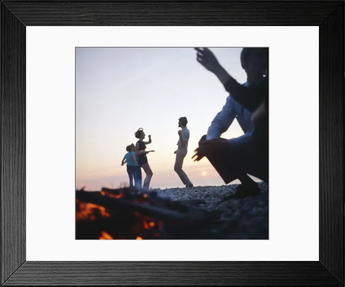 Framed Print : Group of friends enjoying themselves during a day out at the seaside in Greece