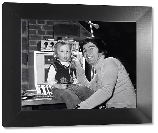 Disc Jockey Tony Blackburn and his son Simon, 3, in their private recording studio in