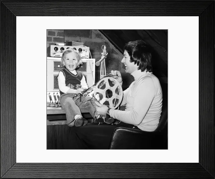 Framed Print : Disc Jockey Tony Blackburn and his son Simon, 3, in their private recording studio in