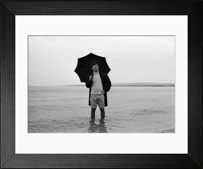 Framed Print : Tony Blackburn on holiday in Poole, Dorset. Summer weather there has not been very good Framed Print : Tony Blackburn on holiday in Poole, Dorset. Summer weather there has not been very good