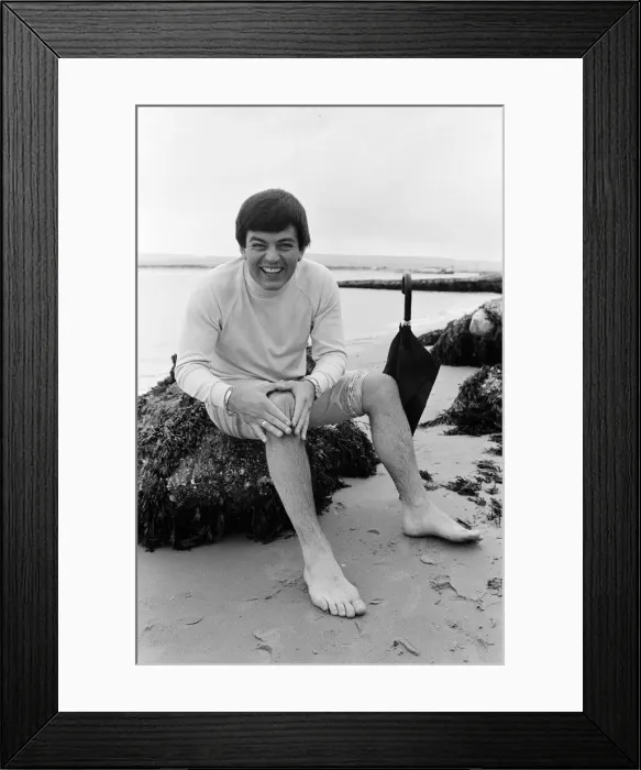 Framed Print : Tony Blackburn on holiday in Poole, Dorset. Summer weather there has not been very good