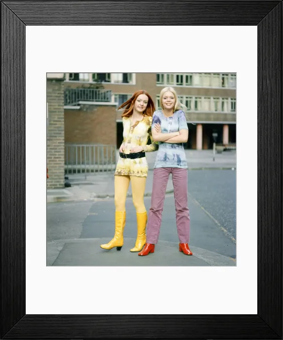 Framed Print : Tie-dye shirts worn by models, Jane (red hair) and Linda (blond hair). 3rd March 1970