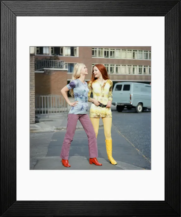 Framed Print : Tie-dye shirts worn by models, Jane (red hair) and Linda (blond hair). 3rd March 1970