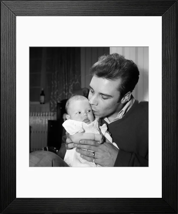 Framed Print : Singer Marty Wilde at home in Chiswick with his baby daughter Kim. 30th January 1961 Framed Print : Singer Marty Wilde at home in Chiswick with his baby daughter Kim. 30th January 1961