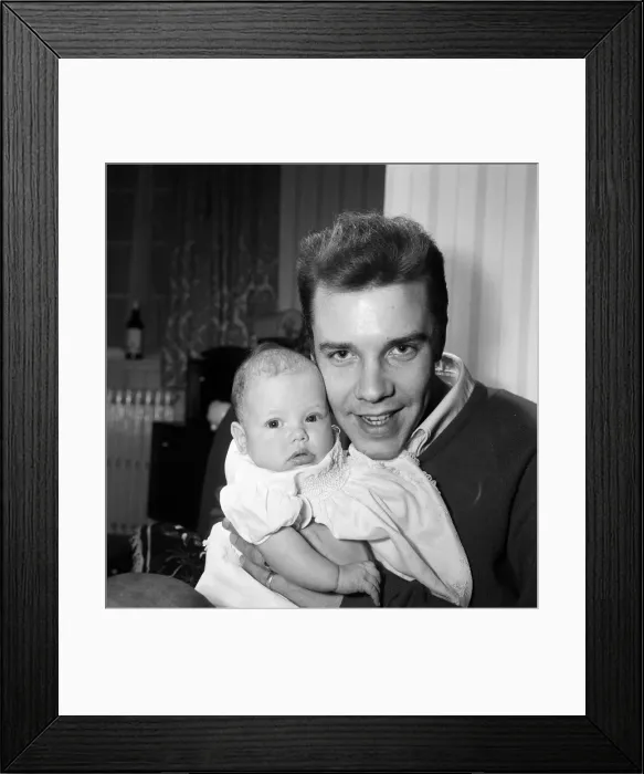 Framed Print : Singer Marty Wilde at home in Chiswick with his baby daughter Kim. 30th January 1961