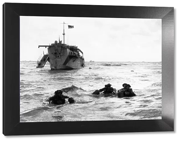 Troops wading ashore from landing craft on Queen Sector, Sword Beach. 6th June 1944