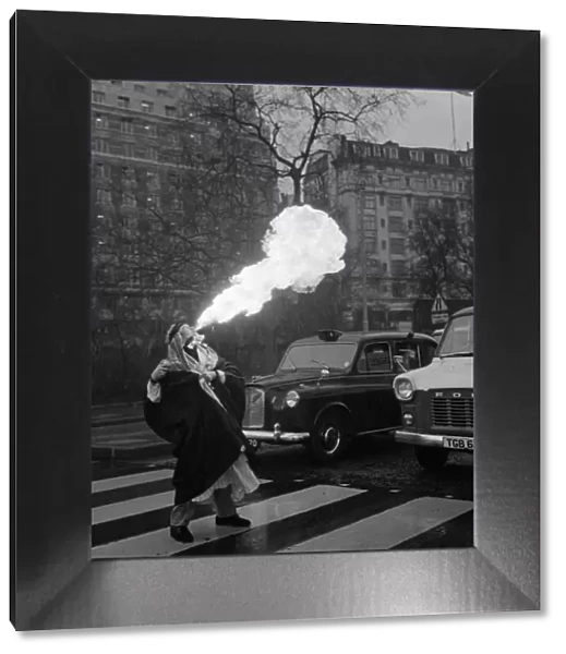 Sammy Kamel, a young Egyptian fire eater stops traffic in London. 23rd April 1970