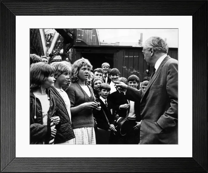 Framed Print : Prime Minister Harold Wilson pauses to chat with a group of children who met his train Framed Print : Prime Minister Harold Wilson pauses to chat with a group of children who met his train