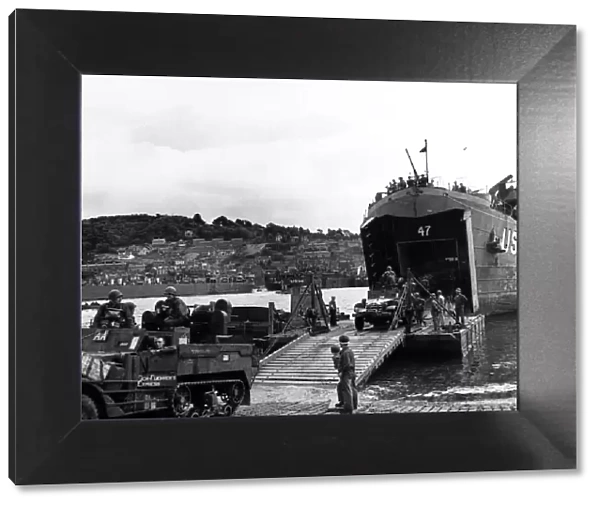 American half track armoured cars disembarking from LST (Landing ship tank