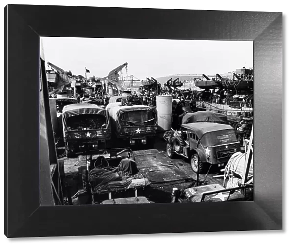 American vehicles loaded aboard landing ships in the river Dart during preparations for
