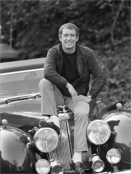 John Nettles, actor, pictured on the set of Bergerac. He is sitting on the car his
