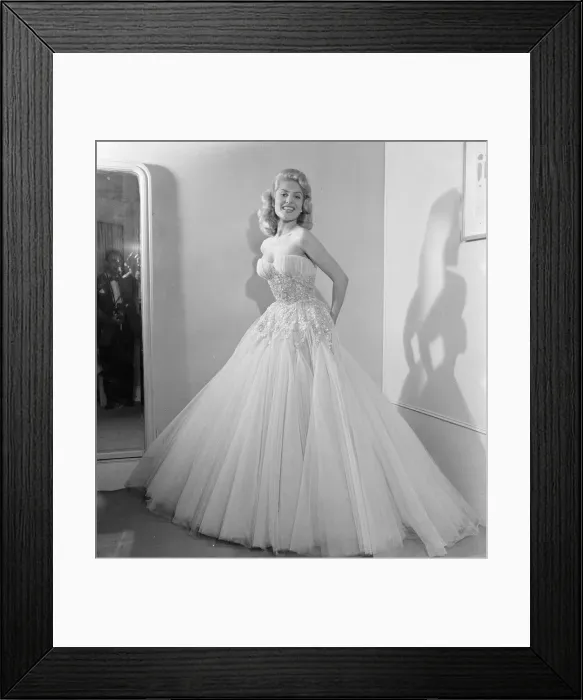 Framed Print : Belinda Lee, British actress tries on dress designed by Julie Harris Framed Print : Belinda Lee, British actress tries on dress designed by Julie Harris