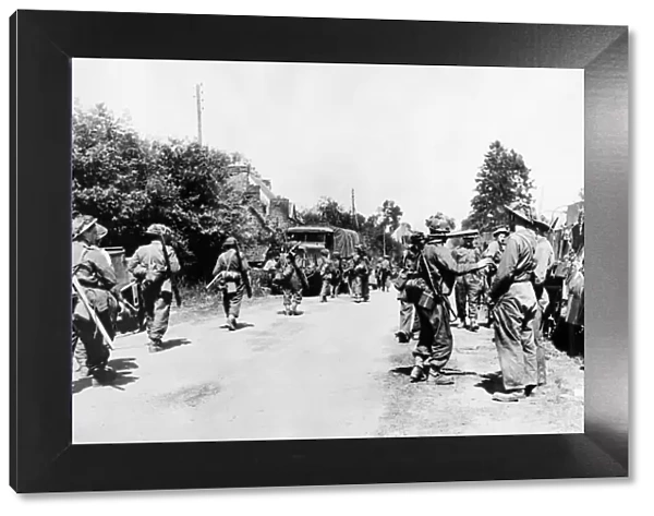 British troops about to pass through Normandy village after the landings