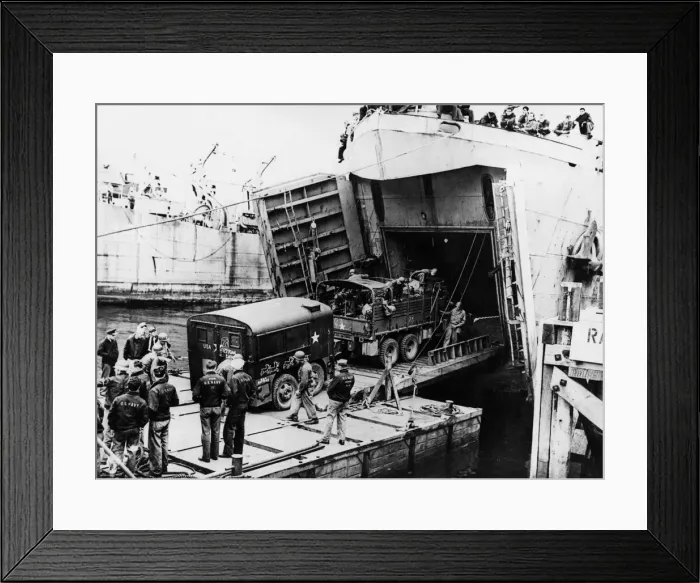 Framed Print : A heavy truck pulls a field kitchen up the bow ramp of an LST (Landing Ship Tank