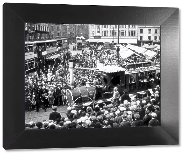 A Trent Motor Traction Company tableau movers through the crowds in Derby Market Place