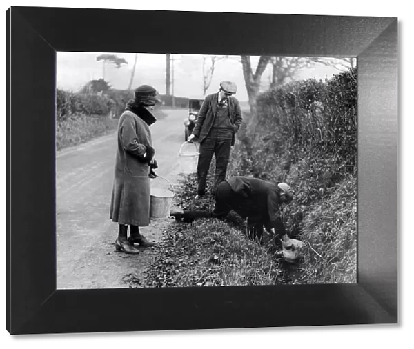Villagers collecting water from a roadside ditch, Ilketshall, Suffolk. 22nd January 1933
