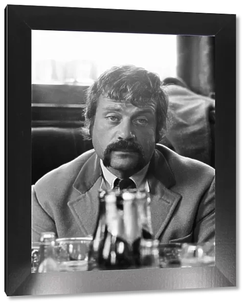 Oliver Reed, British actor, enjoys a few drinks at his local pub, The Dog and Fox