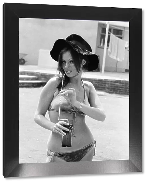 Vicki Michelle, British actress, relaxes in her garden with a cold drink, Epping, Essex