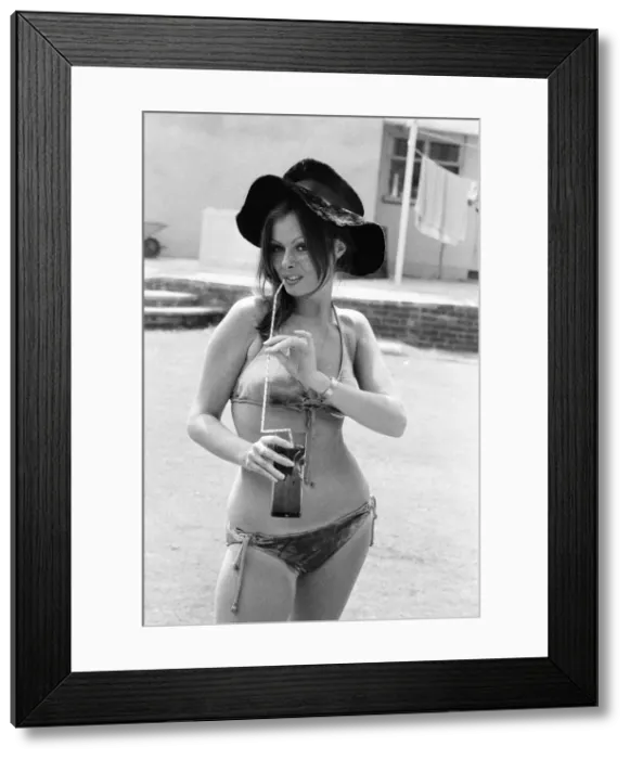 Framed Print : Vicki Michelle, British actress, relaxes in her garden with a cold drink, Epping, Essex Framed Print : Vicki Michelle, British actress, relaxes in her garden with a cold drink, Epping, Essex