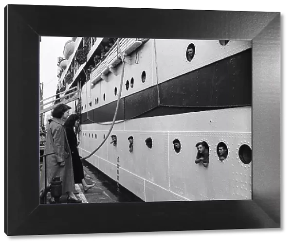 Suez Crisis 1956 Soldiers lean out of portholes on the troopship Empire Ken as it