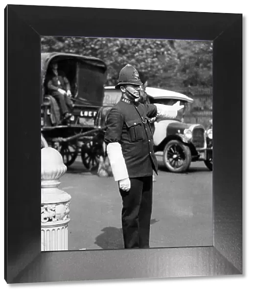 A London policeman on traffic duty with heavy bulk helmet, tunic