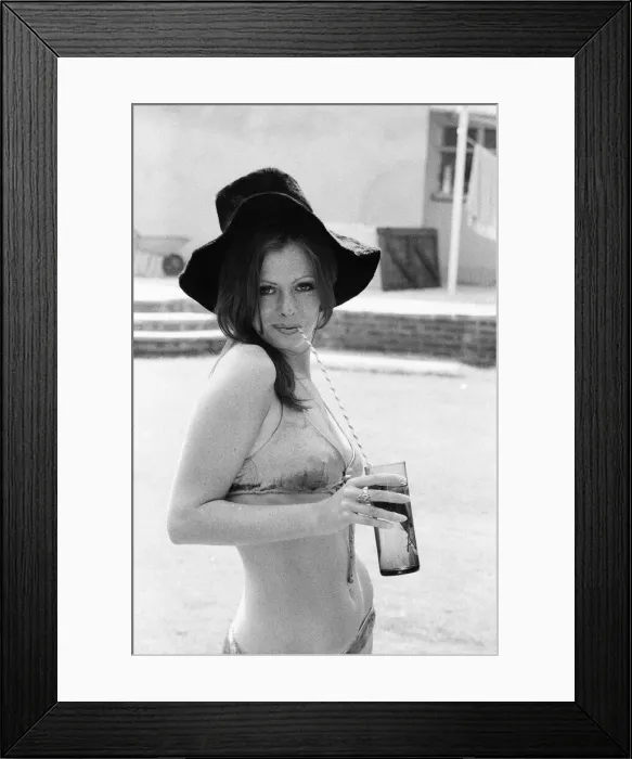 Framed Print : Vicki Michelle, British actress, relaxes in her garden with a cold drink, Epping, Essex