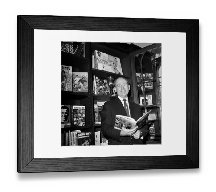 Framed Print : Football agent Ken Stanley reading a George Best annual. 18th February 1970 Framed Print : Football agent Ken Stanley reading a George Best annual. 18th February 1970
