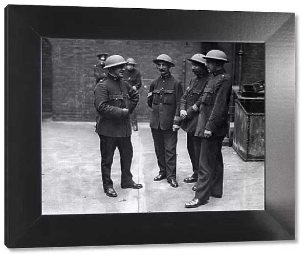 Steel helmets for the London special constables. 'Do you find them heavy