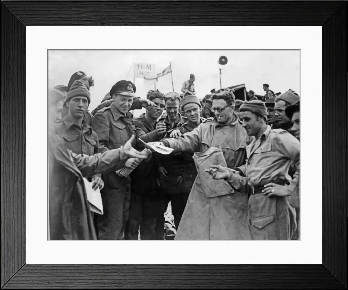 Framed Print : Daily Mirror war correspondent handing out copies to the troops on the Normandy invasion