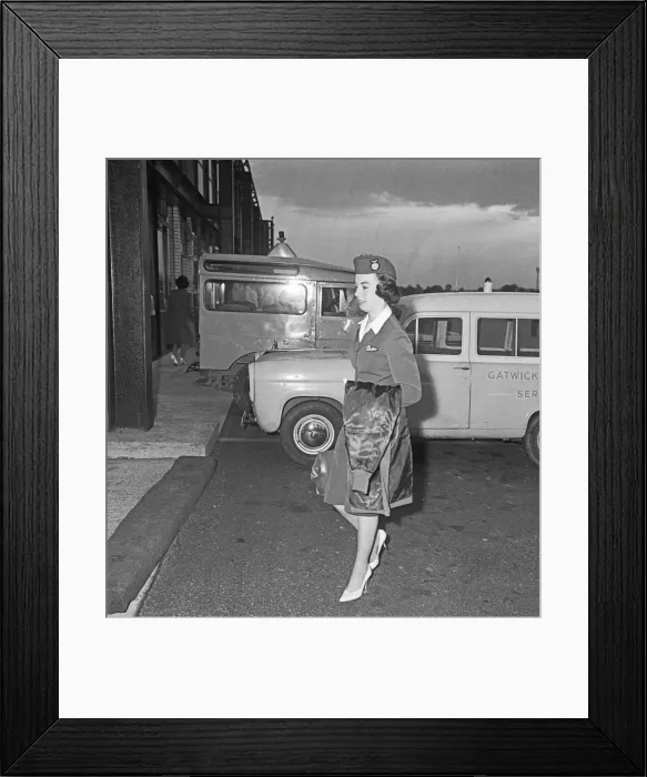 Framed Print : An Air Stewardess of Overseas Aviation walk towards the terminal at Gatwick Airport after Framed Print : An Air Stewardess of Overseas Aviation walk towards the terminal at Gatwick Airport after