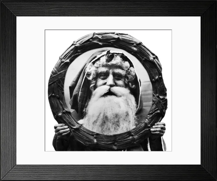 Framed Print : Father Christmas looking through a Holly Wreath. 12th December 1921 Framed Print : Father Christmas looking through a Holly Wreath. 12th December 1921