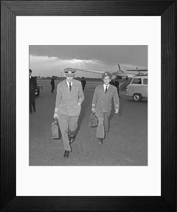 Framed Print : The pilot and flight engineer of Overseas Aviation walk towards the terminal at Gatwick Framed Print : The pilot and flight engineer of Overseas Aviation walk towards the terminal at Gatwick
