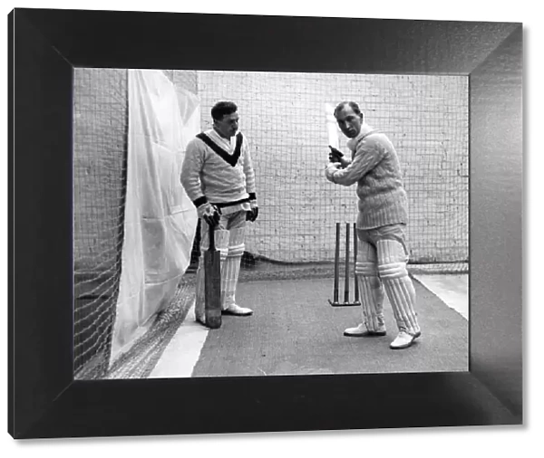 Sandham demonstrating a batting stroke to a pupil at the indoor cricket school opened at