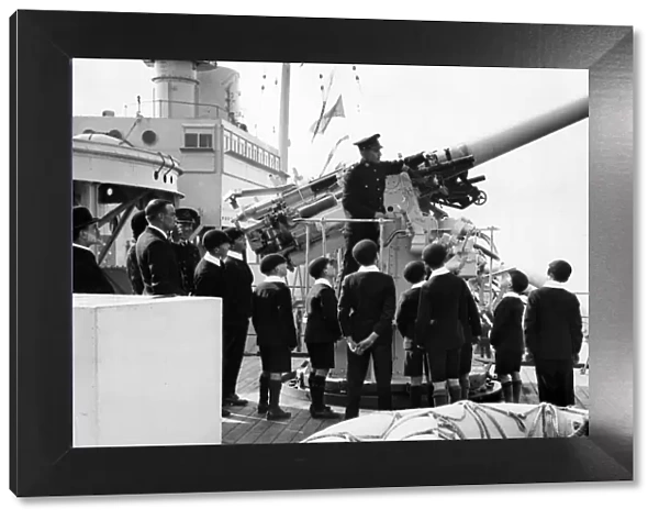 View day of HMS London. Schoolboys watching a demonstration of an aircraft gun