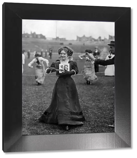 Miss E Barnwell wins the egg and spoon race at a theatrical sports meeting. July 1910