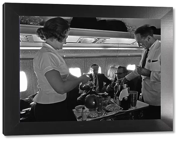 BOAC Steward and Stewardess serving drinks during a proving flight between Heathrow