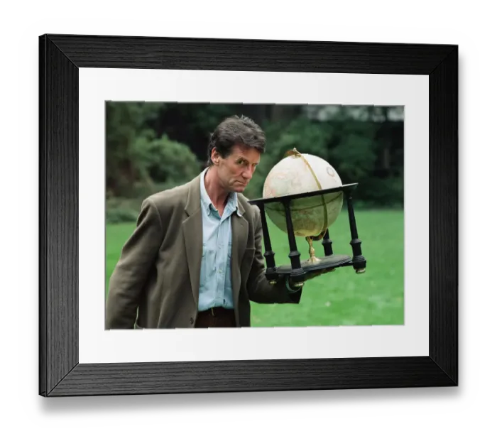 Framed Print : Writer and actor Michael Palin with a globe. 8th October 1992