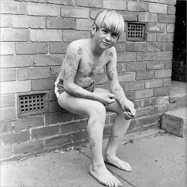 Joseph Daugherty, aged 14, showing off some of his 60 tattoos