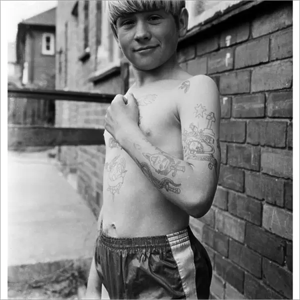 Joseph Daugherty, aged 14, showing off some of his 60 tattoos