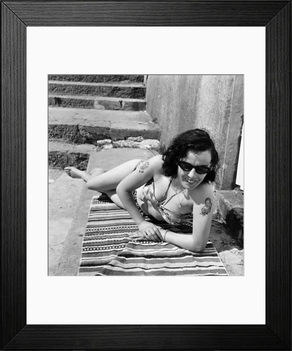 Framed Print : Irene Redpath shows of her tattoos as she relaxes on the beach. 11th June 1962 Framed Print : Irene Redpath shows of her tattoos as she relaxes on the beach. 11th June 1962