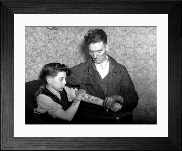 Framed Print : 14-year-old Arthur Waterworth of Droylsden shows off his tattooed forearms to his father