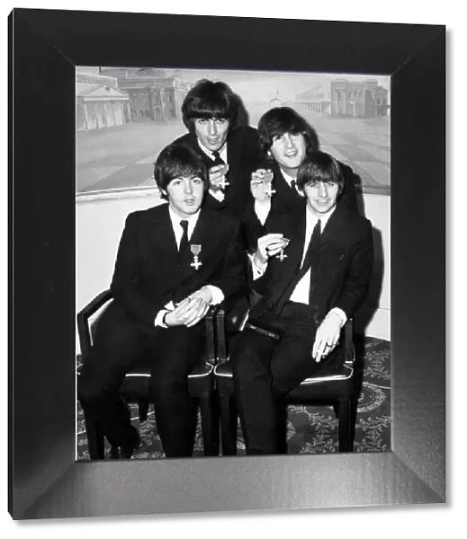 The Beatles holding their MBE s. (Members of the British Empire