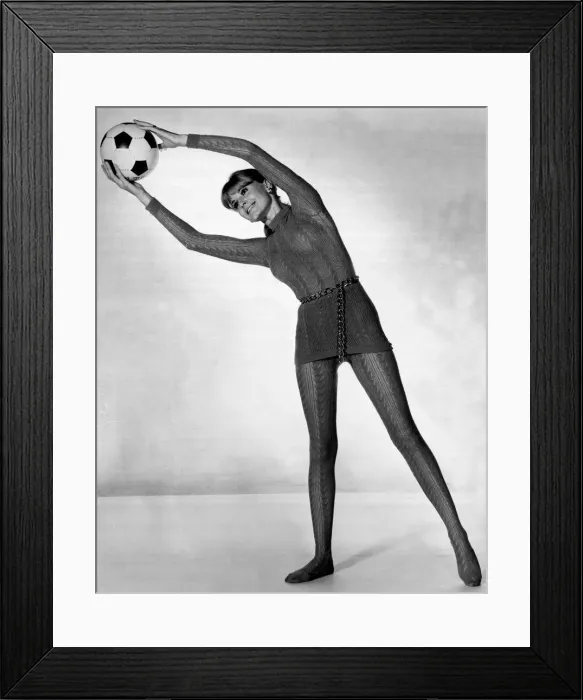 Framed Print : Women - Exercise Feature stretching with a football Framed Print : Women - Exercise Feature stretching with a football